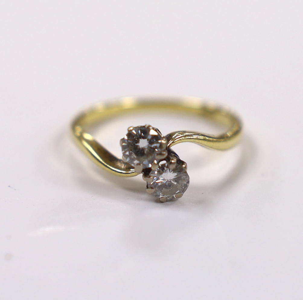 An 18ct and two stone diamond set crossover ring, size M, gross weight 2.8 grams
